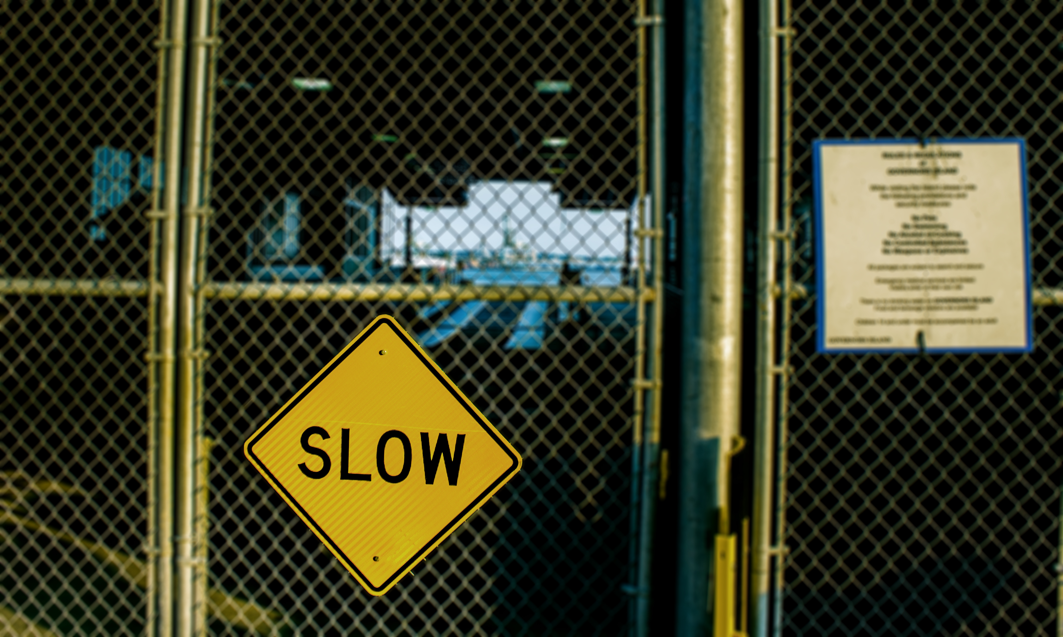 slow sign on fence