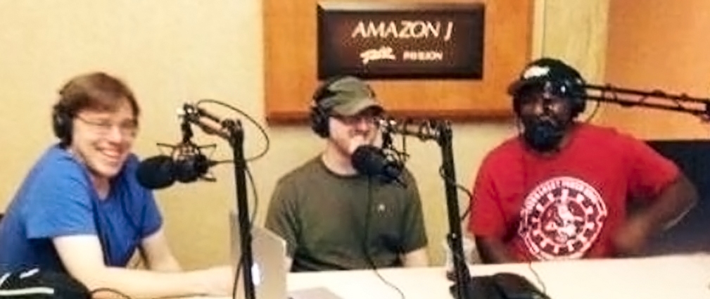 nate meyvis, andrew brokos and carlos welch in front of microphones recording the thinking poker podcast outside the Amazon room at the World Series of Poker at the Rio Hotel in Las Vegas